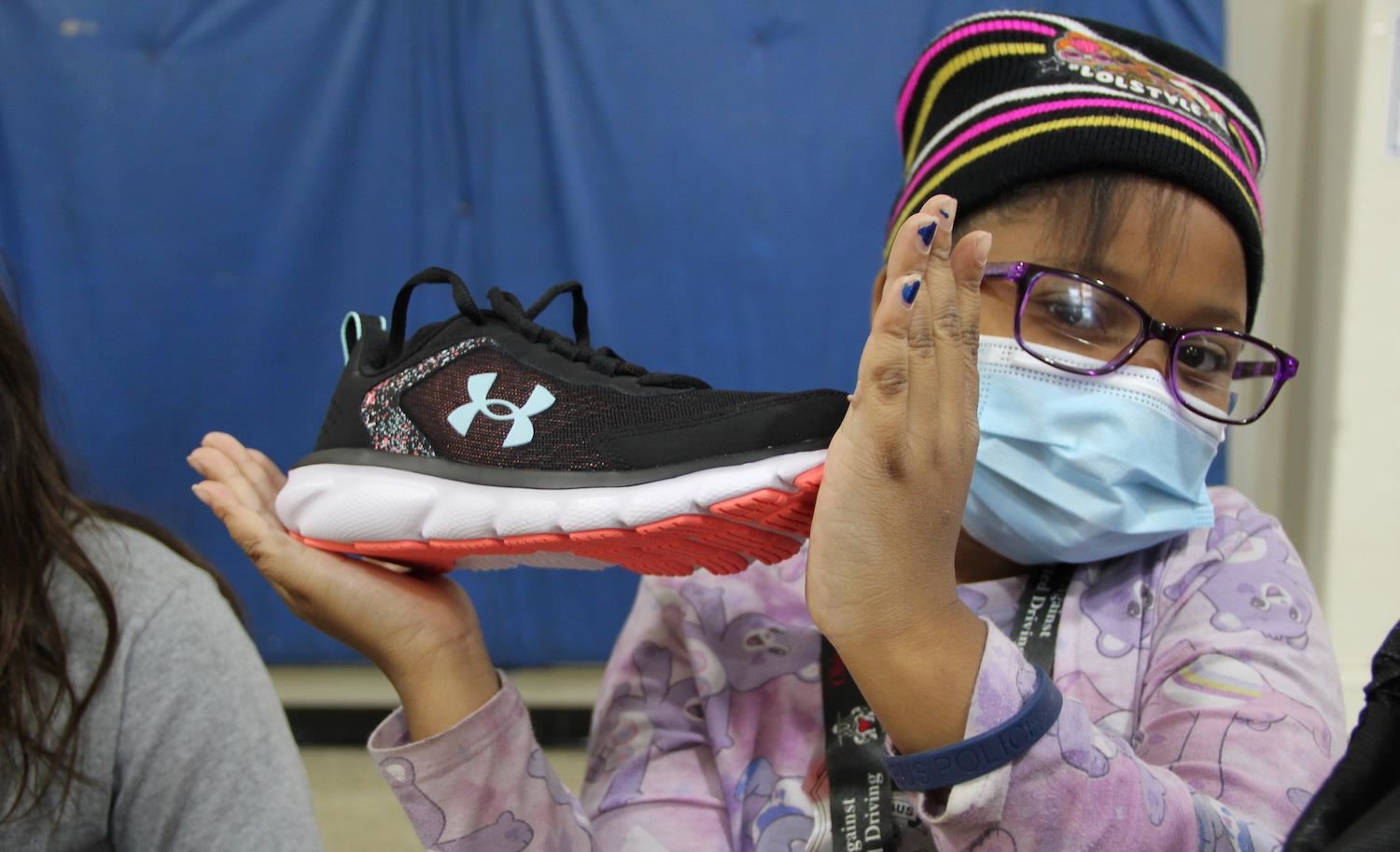 Student holding shoes